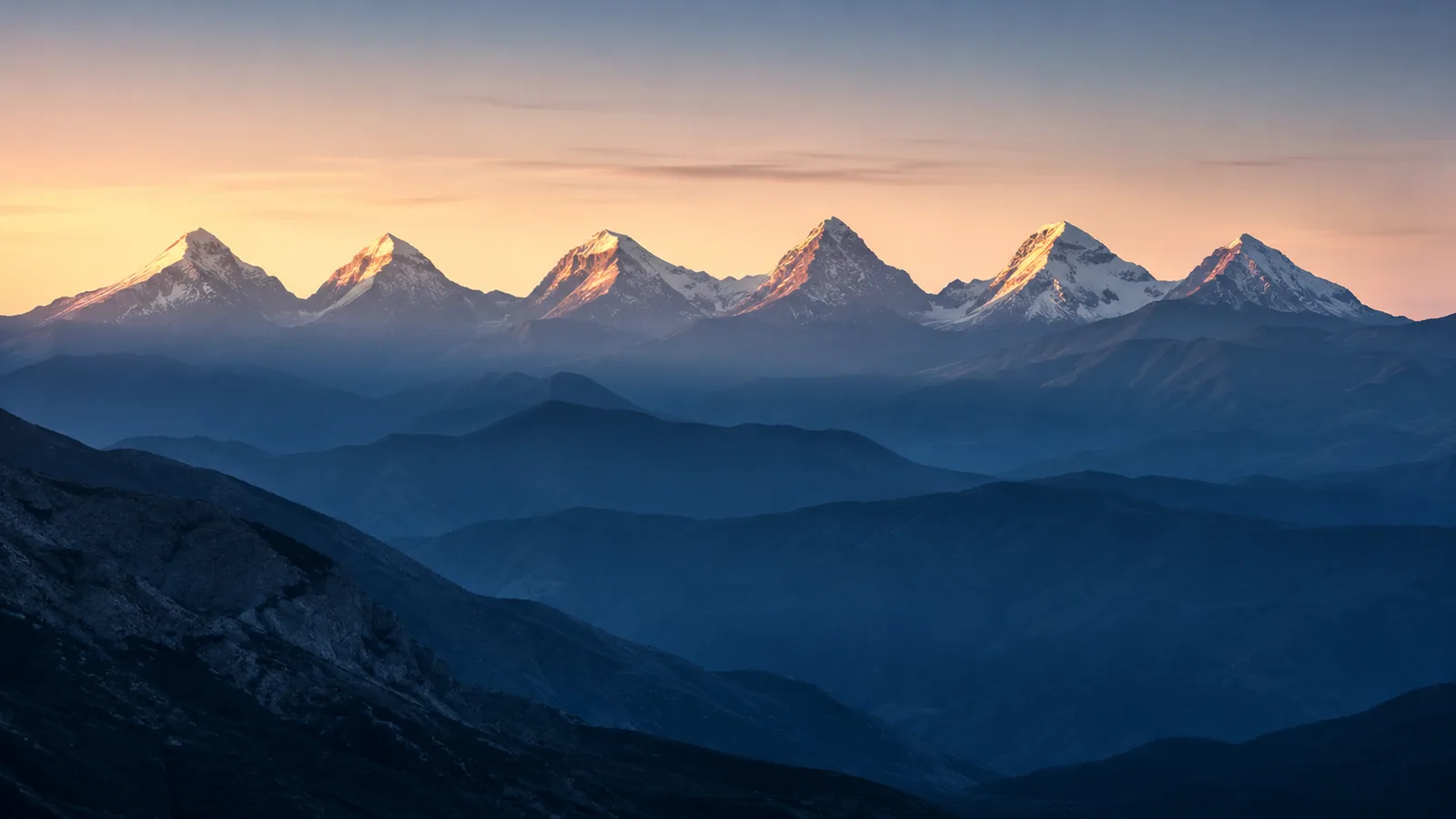 Zes besneeuwde bergtoppen die het eerste ochtendlicht vangen boven een blauw berglandschap, als beeld voor de zes domeinen van het PR6-model.